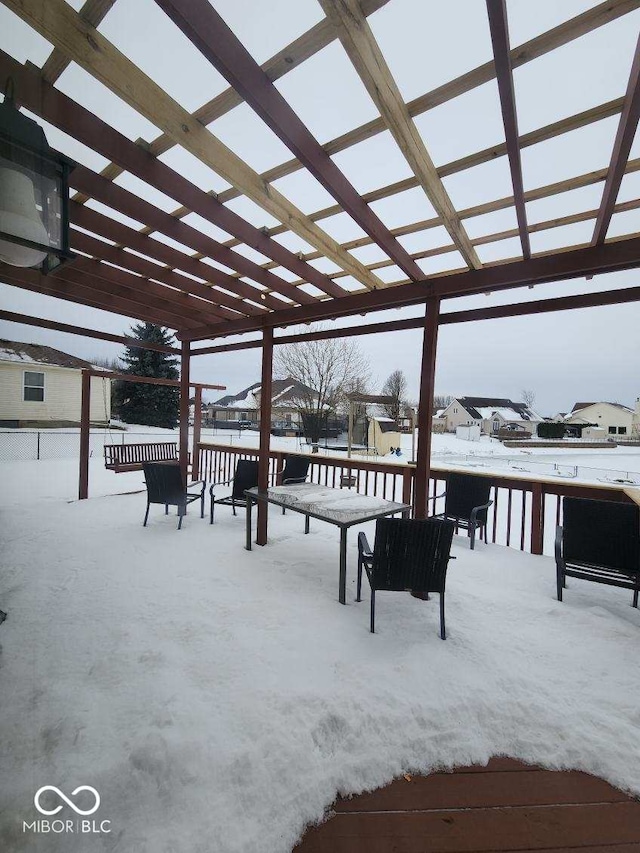 snow covered deck with a pergola