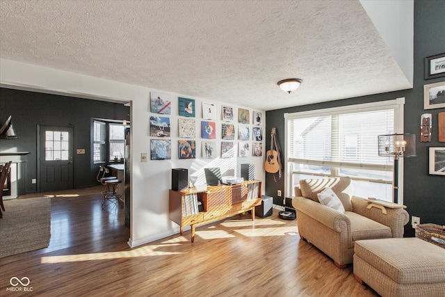 sitting room with a textured ceiling and hardwood / wood-style floors