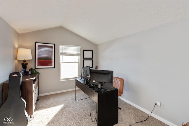 office space with light colored carpet and vaulted ceiling