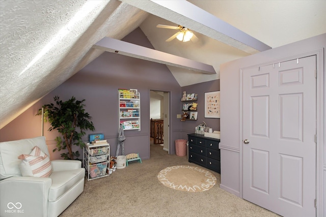 living area with a textured ceiling, carpet floors, ceiling fan, and vaulted ceiling with beams