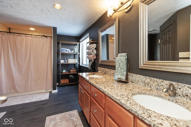 bathroom featuring vanity, a textured ceiling, and hardwood / wood-style floors