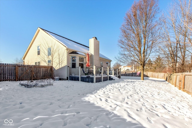 snow covered property featuring a deck