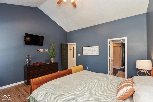 bedroom with lofted ceiling, ensuite bathroom, ceiling fan, and hardwood / wood-style flooring