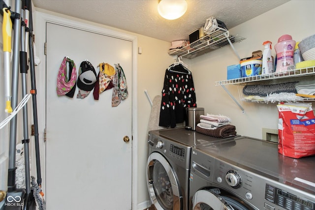 laundry room with washer and dryer and a textured ceiling