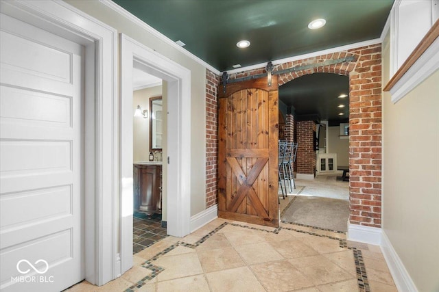 hall featuring ornamental molding and light tile patterned floors