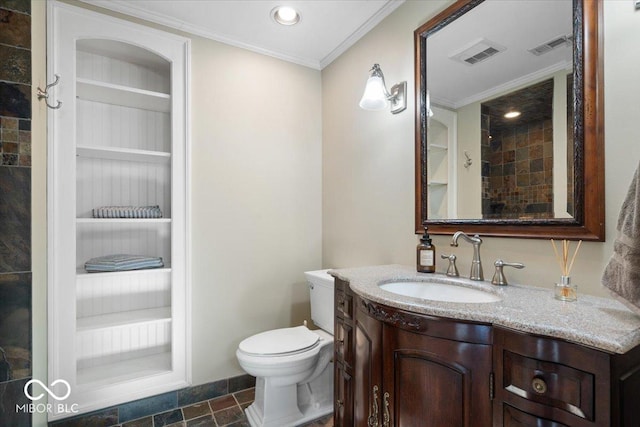 bathroom with built in shelves, crown molding, vanity, and toilet