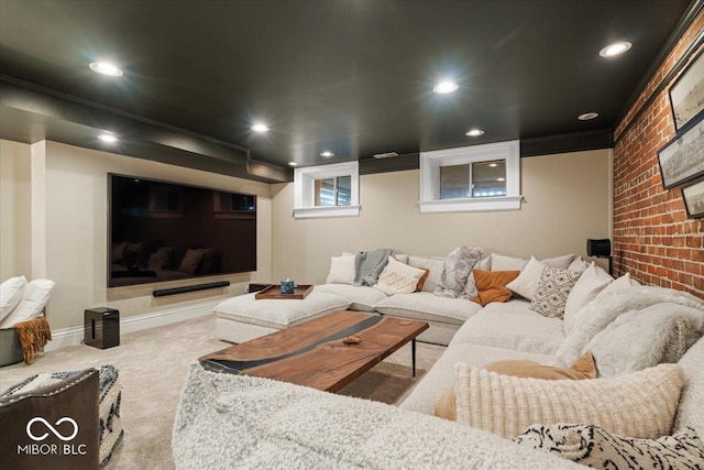 carpeted home theater featuring brick wall