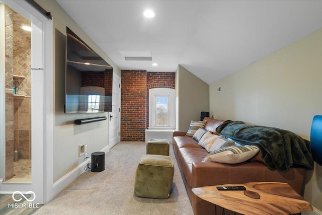 carpeted living room featuring brick wall