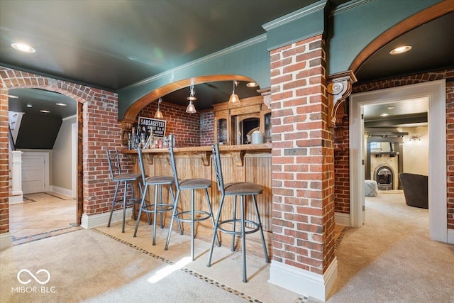 kitchen with brick wall, a fireplace, and light carpet