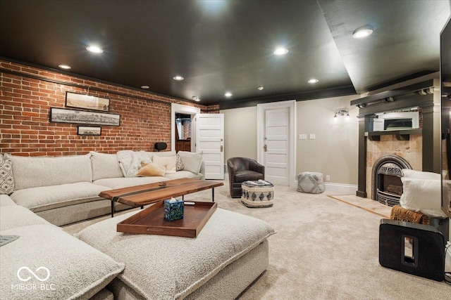 living room featuring brick wall and carpet