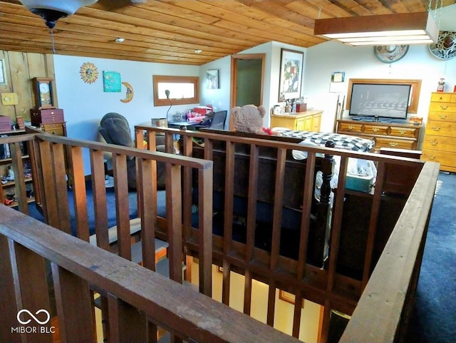 interior space with carpet, wooden ceiling, and vaulted ceiling