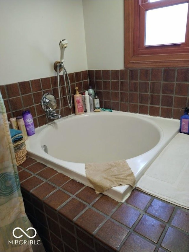 bathroom featuring tiled bath