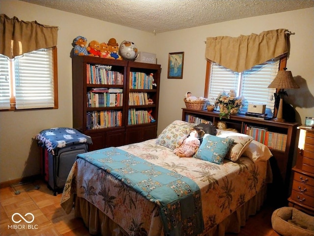 bedroom featuring parquet flooring and a textured ceiling