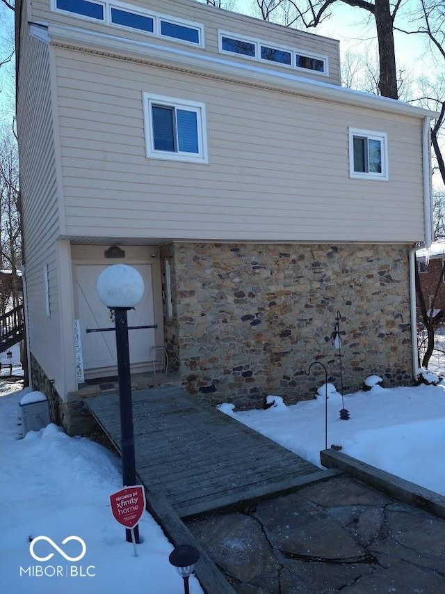 view of snow covered exterior featuring a garage