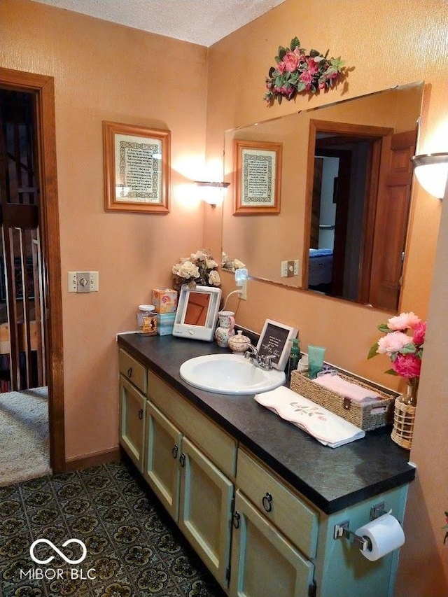 bathroom featuring tile patterned flooring and vanity