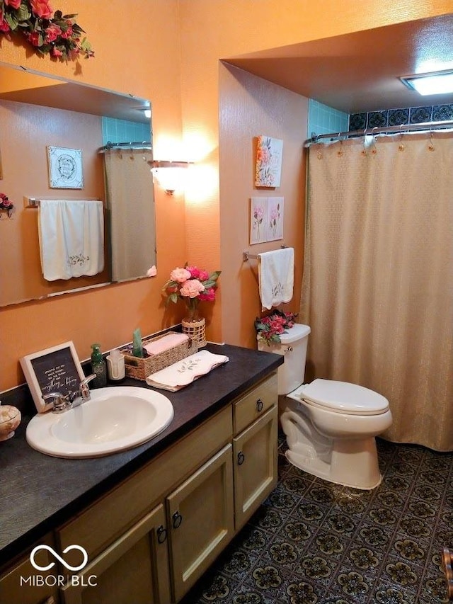 bathroom featuring tile patterned floors, vanity, and toilet