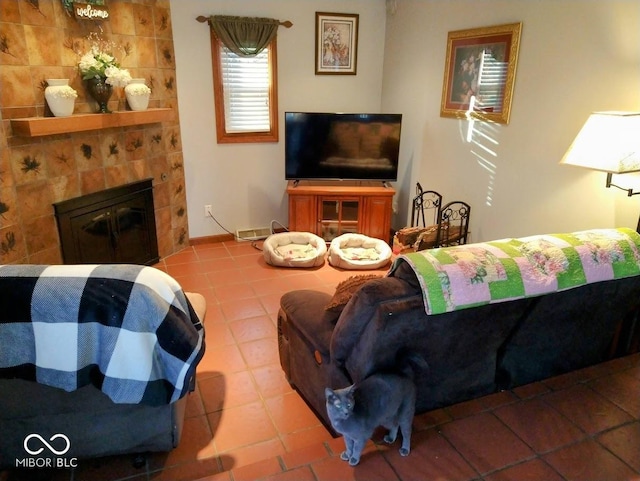 tiled living room with a tiled fireplace