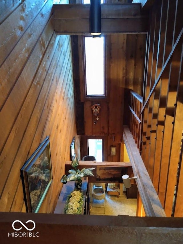 stairs featuring wooden walls