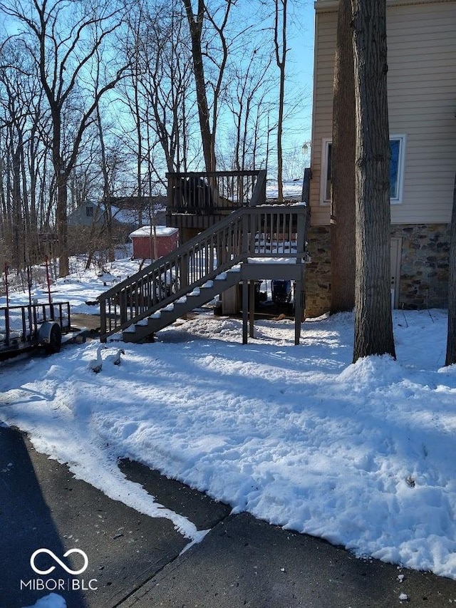 yard layered in snow with a deck