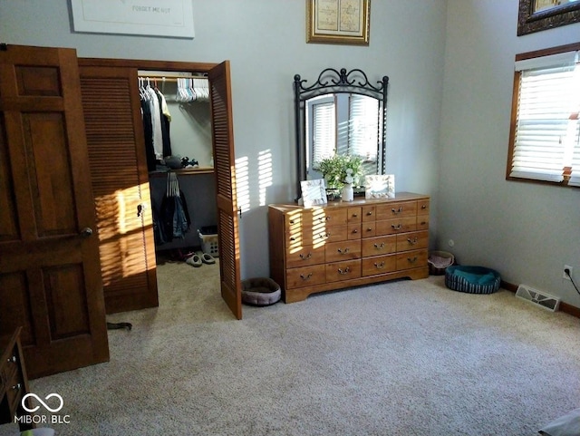 carpeted bedroom with a closet