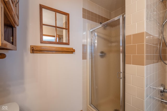 bathroom featuring toilet and walk in shower