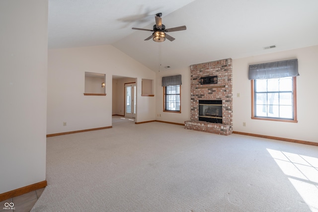 unfurnished living room with a fireplace, ceiling fan, vaulted ceiling, and light colored carpet