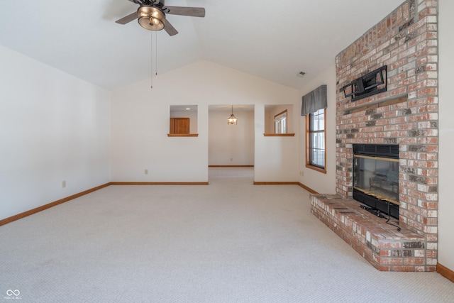 unfurnished living room featuring ceiling fan, light colored carpet, vaulted ceiling, and a fireplace