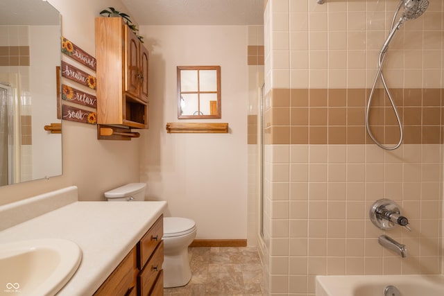 full bathroom featuring toilet, vanity, and tiled shower / bath combo