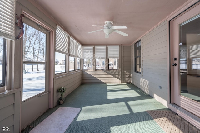 sunroom featuring ceiling fan