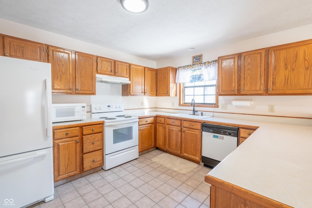 kitchen with white appliances, a textured ceiling, and sink