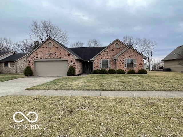 ranch-style home featuring a garage and a front yard