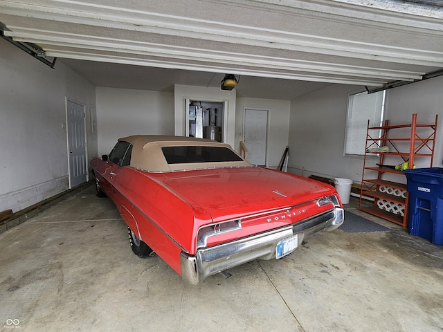 garage featuring a garage door opener and water heater