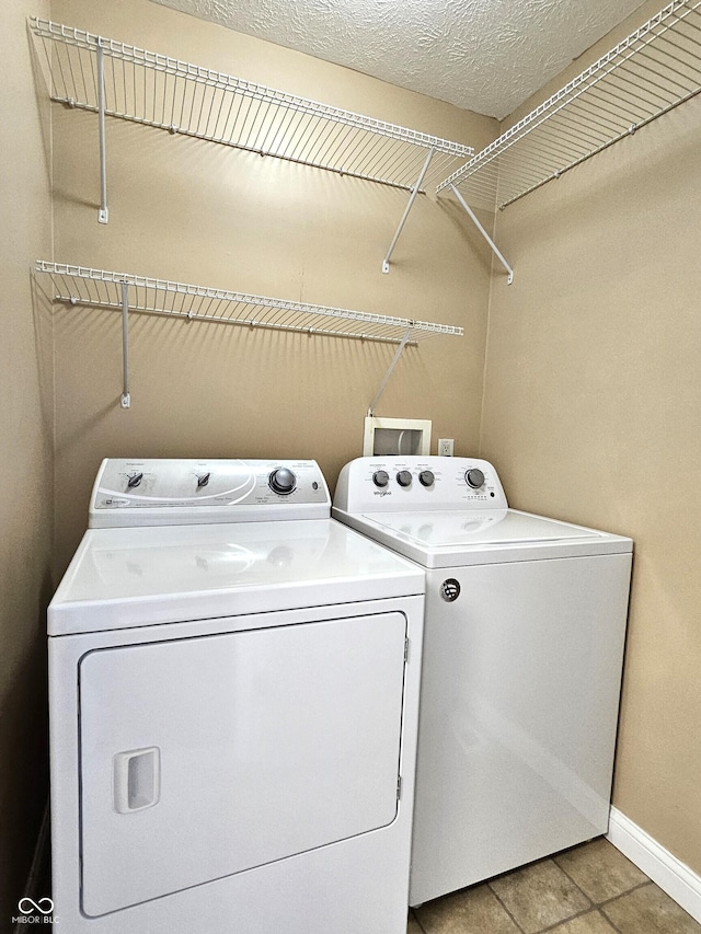 washroom with independent washer and dryer and tile patterned floors