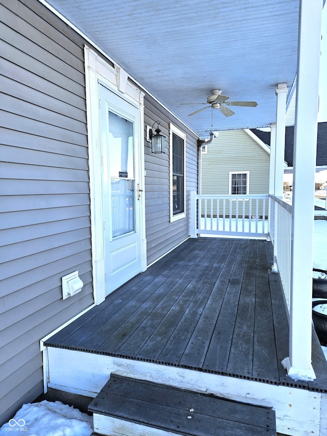 wooden deck featuring ceiling fan