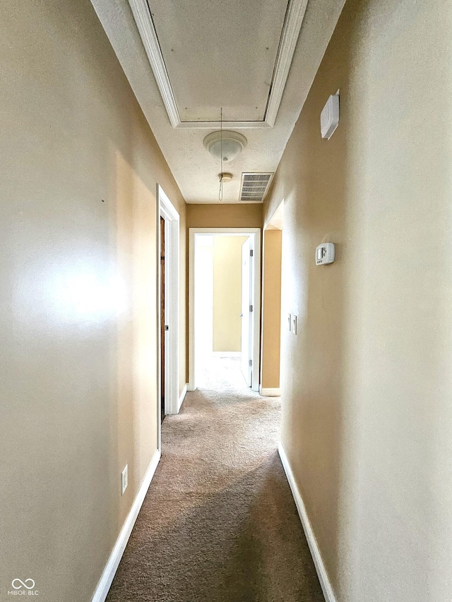 hallway with carpet flooring and ornamental molding