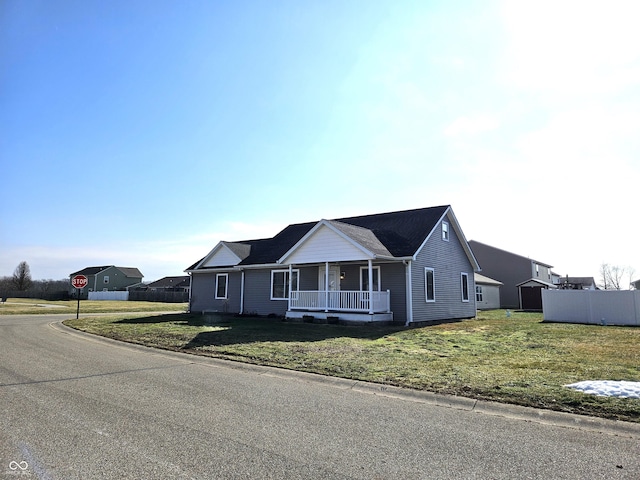 single story home featuring a front yard and covered porch