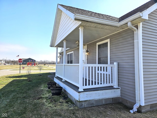 exterior space featuring a porch, a playground, and a lawn