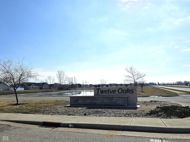 community / neighborhood sign featuring a water view