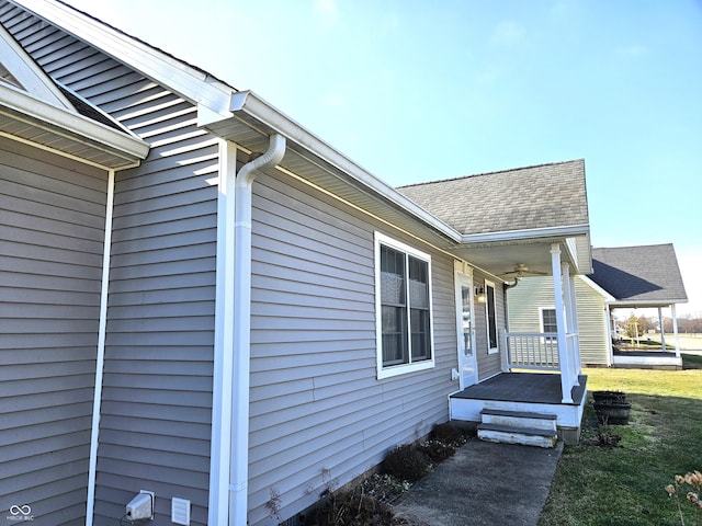 view of home's exterior featuring a lawn and covered porch