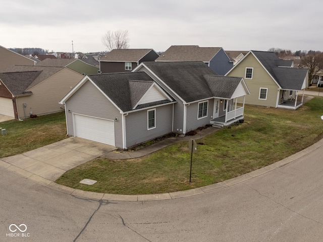 view of front of house featuring a garage, a front lawn, and covered porch