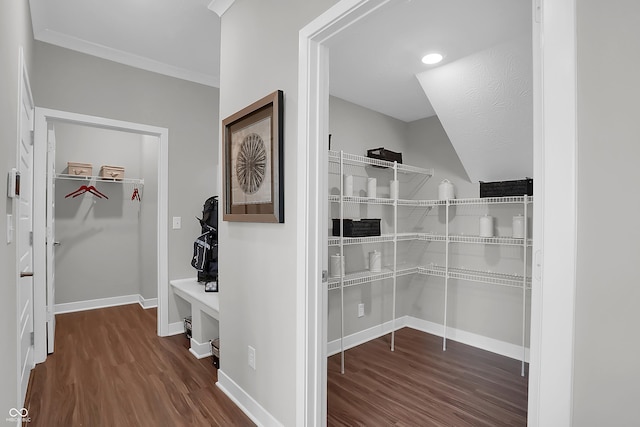 corridor featuring baseboards and wood finished floors