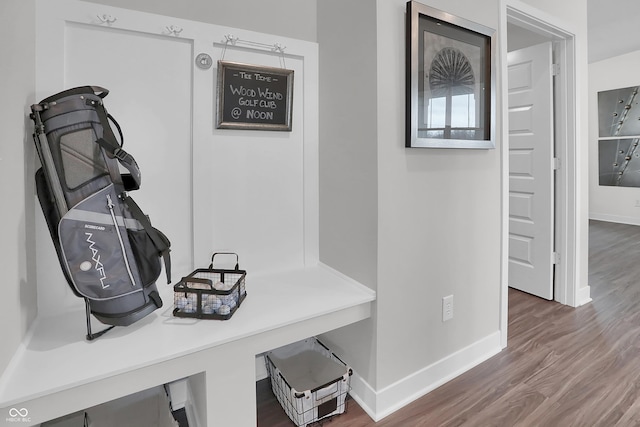 interior space featuring baseboards and wood finished floors