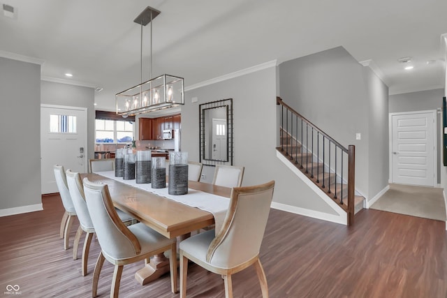 dining room featuring ornamental molding, stairway, baseboards, and wood finished floors