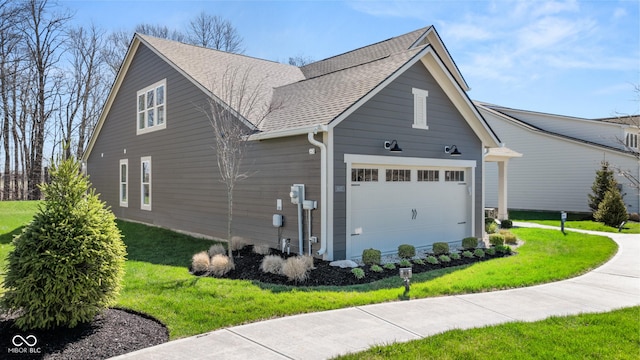 view of property exterior featuring a shingled roof, a yard, and a garage