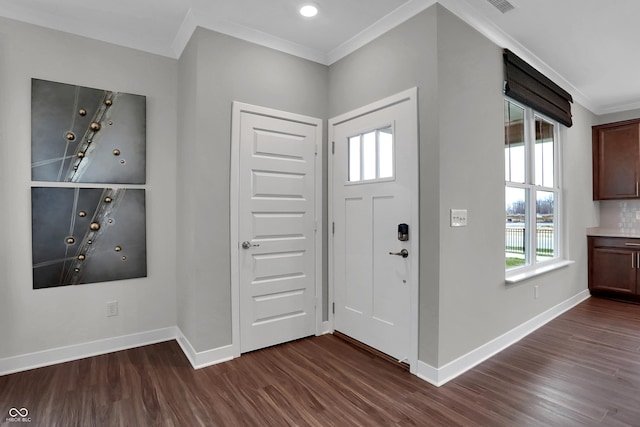 foyer with visible vents, baseboards, dark wood finished floors, and crown molding