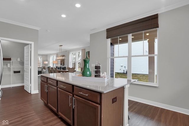 kitchen with dark wood-type flooring, recessed lighting, a kitchen island, and baseboards