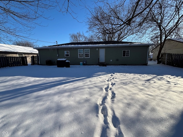 view of snow covered back of property