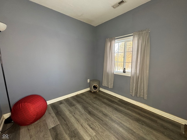 spare room featuring dark wood-type flooring