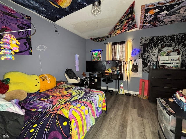 bedroom featuring hardwood / wood-style floors and lofted ceiling