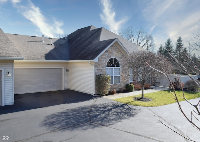 view of front of property featuring a front yard and a garage